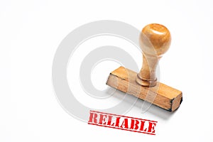 Rubber stamp with reliable sign on white background