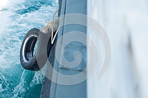 Rubber tire hanging by ferry boat
