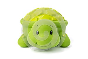 Rubber toy green turtle on a white background. Child`s toy green turtle isolated over white background