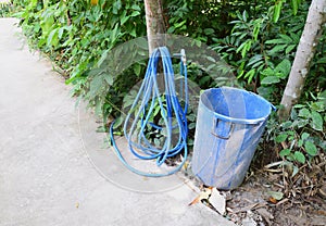 Rubber tube and old bucket