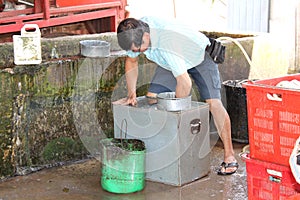 Rubber workers cleaning the rubber Container