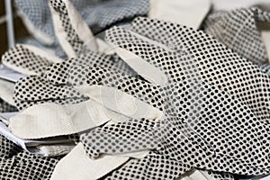 Rubberized grey work gloves hanging on the wall. Part of work-wear and protection equipment.