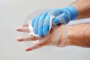 Rubbing hand with antiseptic wipe to sterilize it