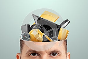 Rubbish in the head, a man`s head is open instead of a brain, various office rubbish. Creative background, unnecessary informatio