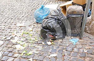 Rubbish plastic bag scattered on street Rome Italy