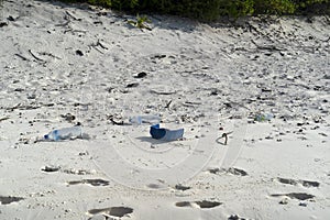 Rubbish on tropical island paradise sandy beach
