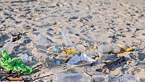 Rubbish and used plastic bottles on the beach. Environmental pollution. Ecological problem
