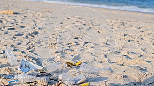 Rubbish and used plastic bottles on the beach. Environmental pollution. Ecological problem