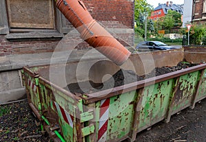 Rubble chute with container on a construction site for construction rubble