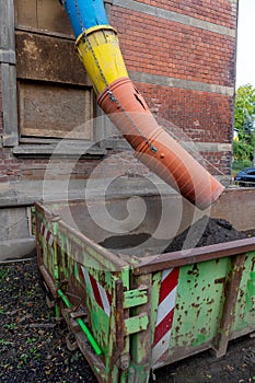Rubble chute with container on a construction site for construction rubble