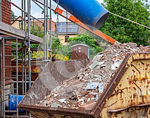 Rubble chute with debris and container on a construction site