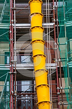 Rubble drain pipes on the external faÃ§ade of a building under construction or renovation