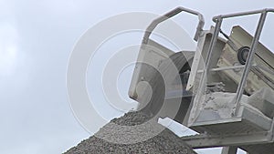 Rubble stones strew from the conveyor belt