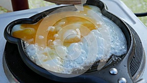 Rube Goldberg Machine. The egg is fried in a pan