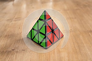 Madrid, Spain; 8 february 2019: Rubik pyramidal cube solved in a wood table