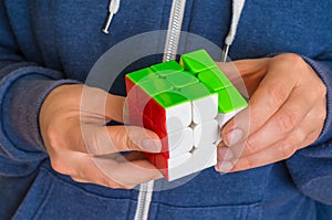Rubik`s cube in female hands - game for solving problems