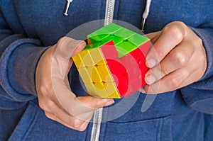Rubik`s cube in female hands - game for solving problems
