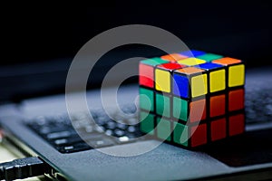 Rubik`s cube on laptop. techincal and business solving problem