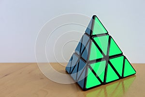 Rubik`s Pyraminx Cube on a Table