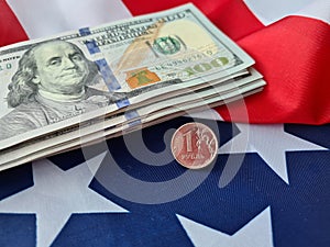 Ruble coin on the background of dollar bills and American flag