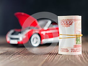 Ruble Notes on toycar background with a raised hood