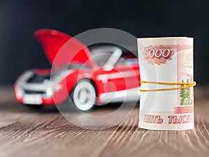 Ruble Notes on toycar background with a raised hood photo