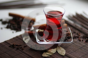 Ruby carcade tea with cinnamon stick, cloves, badyan and bay leaves photo