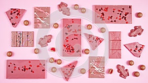 Ruby chocolate selection flat lay overhead on pink background.