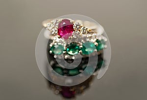 Ruby and emerald rings in diamond settings