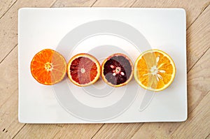 Ruby red blood oranges, navel oranges, and clementines cut in half