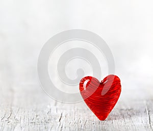 Ruby red Valentines day heart on white wood floor. For Valentine`s, love, and romance