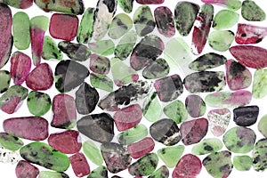 Ruby zoisite stones heap texture on light white isolated background