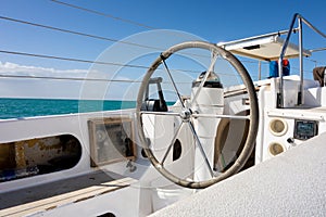 Rudder on a white catamaran ship with no sailor steering it