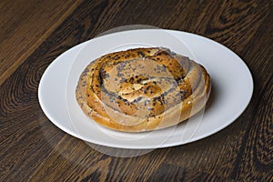 Ruddy chignon on a white plate on the table photo