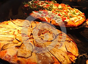 Ruddy dough. Italian pizza in the restaurant`s kitchen oven.