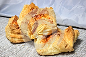 Ruddy khachapuri with puff pastry cheese. Fresh baked goods