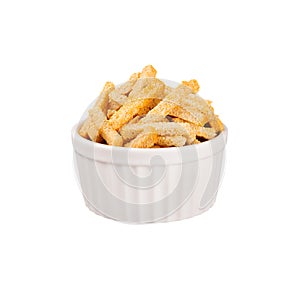 Ruddy sliced wheat bread sticks as croutons in white ceramics bowl isolated on white background.