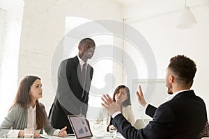 Rude angry african businessman arguing shouting at colleague dur photo