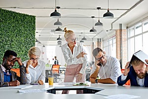 Rude angry female boss executive is dissatisfied irritated by employees, scream