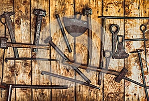 Rudimentary gold mining tools hanging on a wall of planks photo