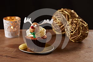 Rudolph reindeer cupcake on Christmas background