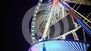 Rue de Paris wheel rotating, amusement ride for night cityscape observation