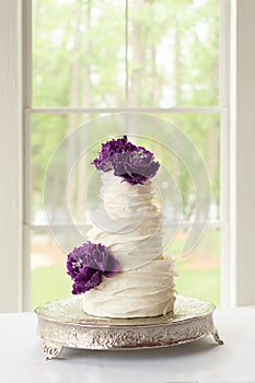 Ruffle Wedding Cake With Edible Purple Sugar Flowers photo