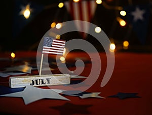 Ruffled American flag and wooden cube calendar with 4th of July, USA Independence Day date, copy space celebratory background. US