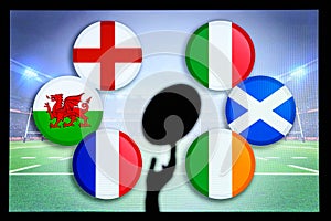 Rugby ball silhouette in hand. Flags of Six Nations, England, Wales, France, Italy, Ireland, Scotland