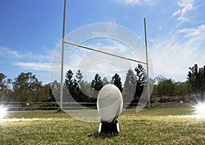 Rugby football positioned in front of the goal posts.