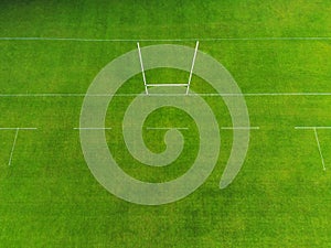 Rugby and Irish national sports camogie, hurling, gaelic football tall goal posts in a green grass training field. Aerial drone