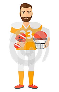 Rugby player with ball and helmet in hands
