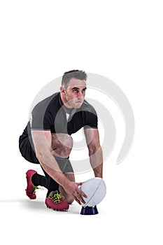 Rugby player getting ready to kick ball