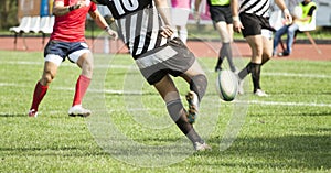 Rugby player kicking the ball